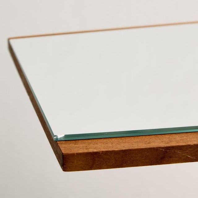 Classic-lined longish teak framed mirror from the 1970s. with some surface scratches and wear on the wooden and mirror parts