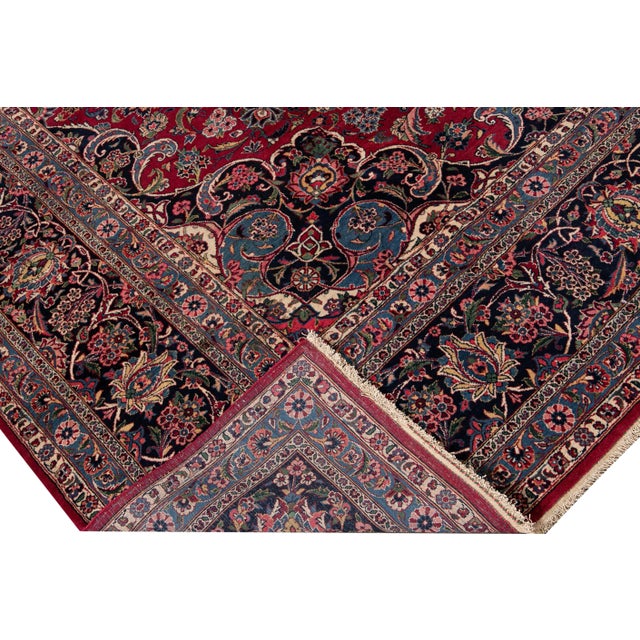 Beautiful 19th century Persian Mohtasham Kashan hand-knotted wool rug with a red field. This Kashan rug has a multi-color...