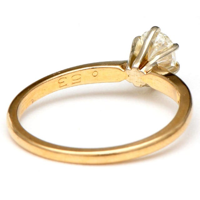 Keep the romance alive with this gorgeous diamond solitaire ring fashioned in 14-karat yellow gold. A classic and...
