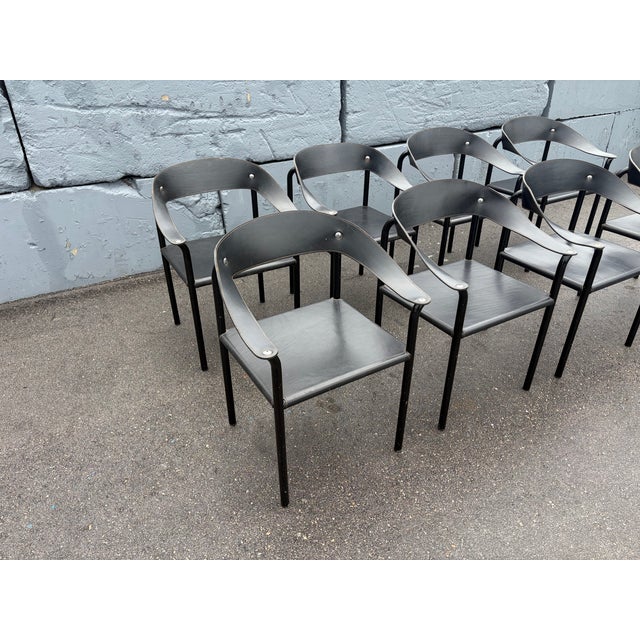 Set of Eight Artelano Black Leather Arm Chairs, Italy 1980s. Steel frame with black finish and black leather. Front arm...