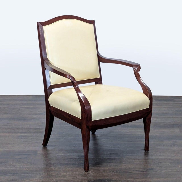 This lounge chair by Therien Studio Workshops features a sturdy dark wood frame and smooth cream leather upholstery. The...