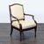 This lounge chair by Therien Studio Workshops features a sturdy dark wood frame and smooth cream leather upholstery. The...