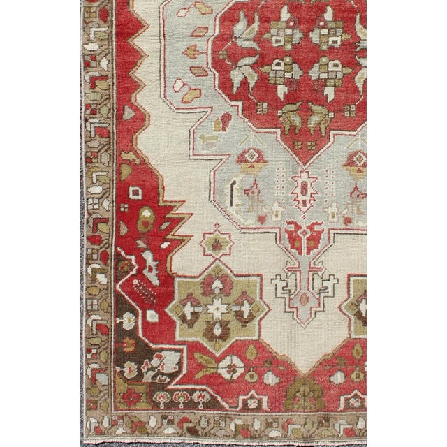 Measures: 4'4 x 7'9 This vintage Turkish Oushak rug features an intricate geometric medallion design. The central...