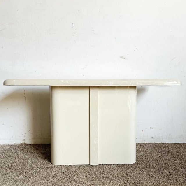 Dive into the elegance of postmodern design with this Cast Cream Faux Marble Console Table. This exquisite table embodies...