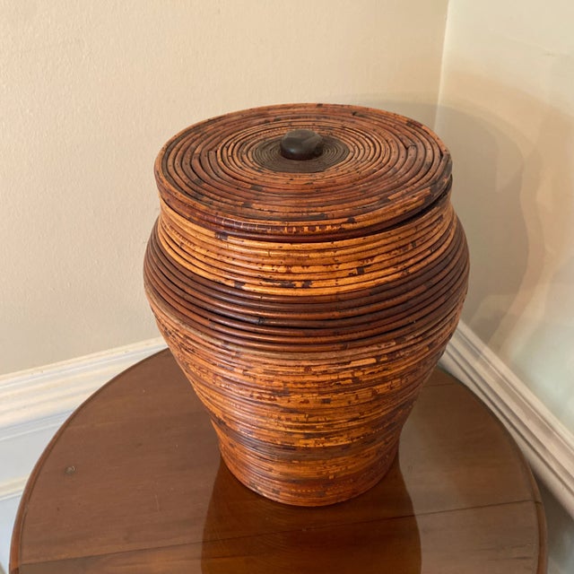 Beautiful large pencil reed lidded floor basket. Great curvature with tapered design. Darker reed adds to visual. Wood...
