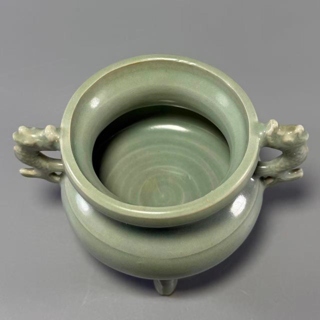 This classic‑styled Longquan celadon tripod censer is finished with soft turquoise‑green glaze. A pair of...