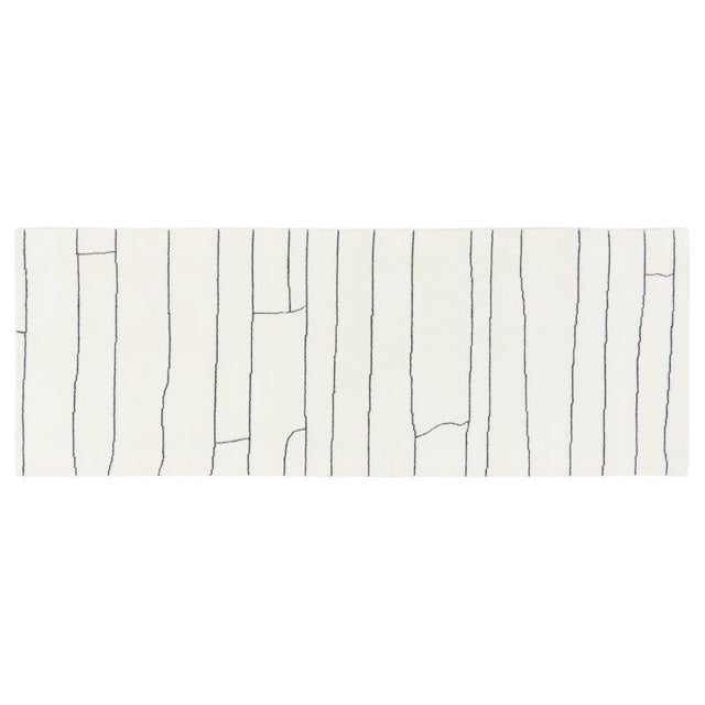 Hand-knotted with care using traditional rug-making techniques, this wool rug blends timeless craftsmanship with a modern...