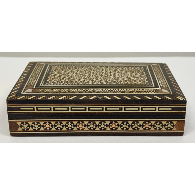 Beautiful floral pattern to this inlaid marquetry box. Hand crafted with different types of wood. Natural age wear. Hinge...