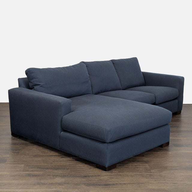 This Room and Board sectional offers plenty of comfortable seating with its spacious chaise lounge. The dark blue fabric...