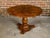 A Biedermeier period table from the 19th century with flame walnut circular top adorned with exquisite radiating motif and...