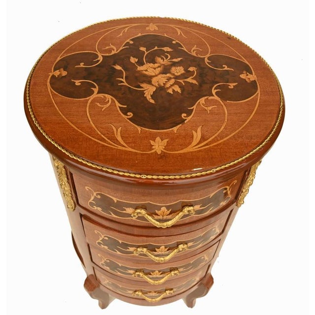 A fine pair of french bedside cabinets in the louis xv style beautifully crafted in kingwood and richly decorated with...