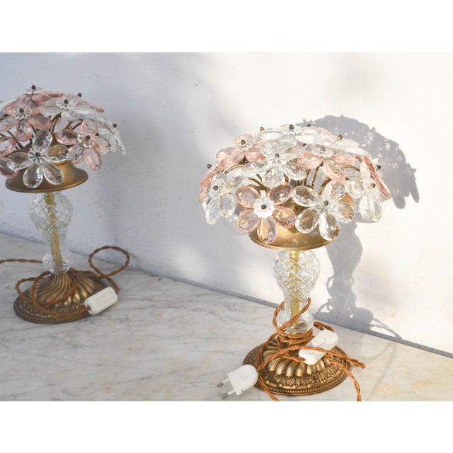 Pair of table lamps with pink and transparent crystal glass flowers. Each lamp has a finely polished brass structure and a...