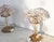 Pair of table lamps with pink and transparent crystal glass flowers. Each lamp has a finely polished brass structure and a...