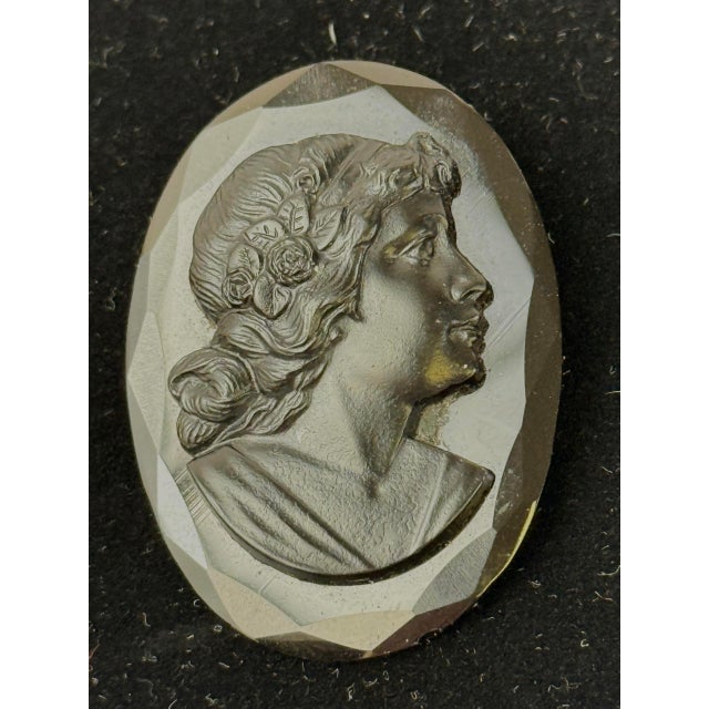 Antique black mourning cameo in French jet glass. Has c-clasp. Measures 1.75” x 1.5”.