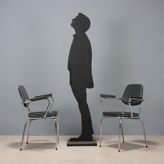 Set of six chairs with armrests, chromed metal frame, foam padding, and vinyl upholstery. Fair condition, needs...