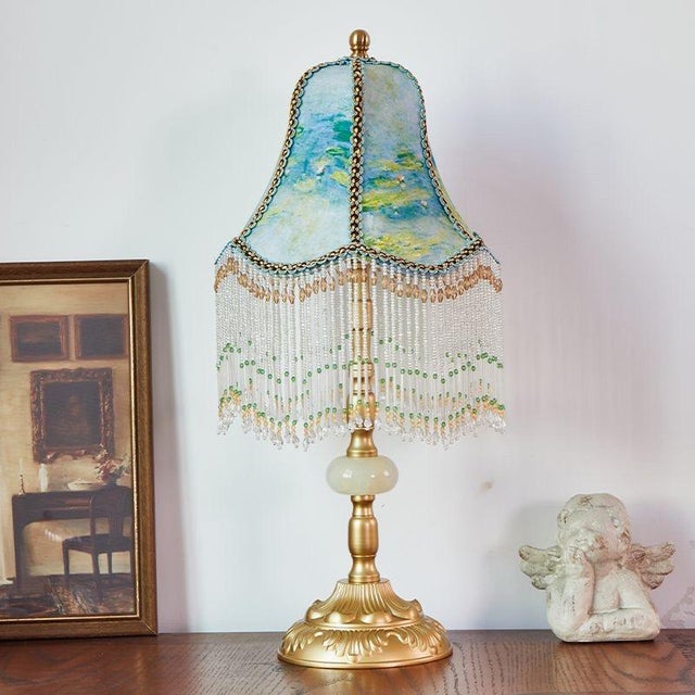 Shade is Monet water lily printed fabric (with beaded chain fringe, strong artistic feel), body is gilded copper + jade-...