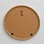 An elegant round wall mirror with a decorative, twisted frame made of brass or brass-plated metal. The piece is designed...
