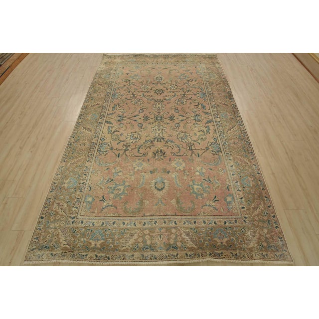 An authentic vintage traditional Tabriz rug hand-knotted with fine wool and natural dyes. This oriental rug features an...