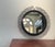 Bring organic texture and mid-century boho charm to your wall with this striking round wicker mirror. Featuring an eye-...