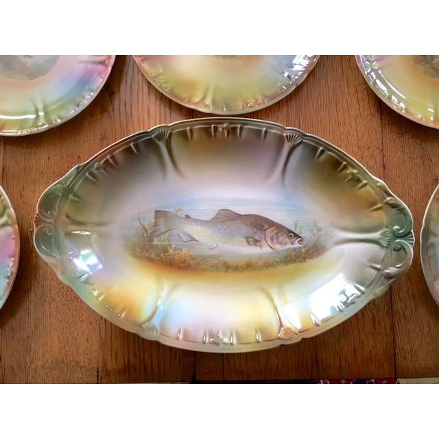 Very nice German Antique game set with fish motif. There is an oval platter and 5 round plates. I love the overall color...