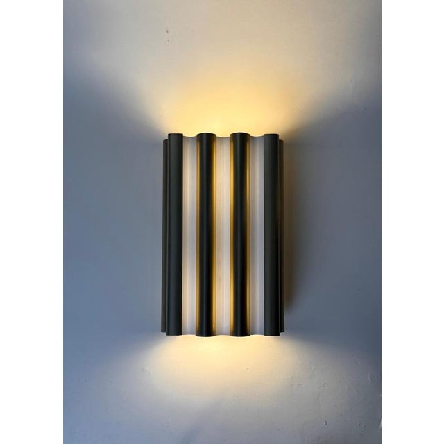 An exceptionally elegant pair of authentic erco wall sconces, crafted in germany and embodying the essence of timeless...