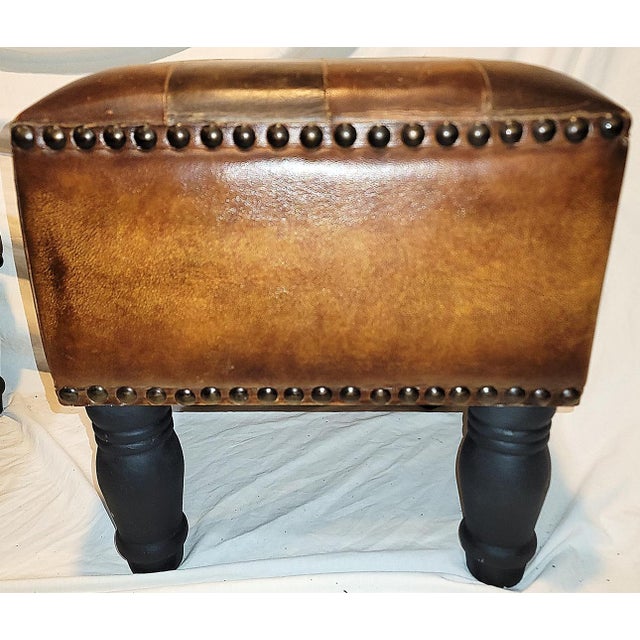 Fun and practical, a naugahyde footstool with painted wood legs, sturdy and devil-may-care 'pleather' top to take any...