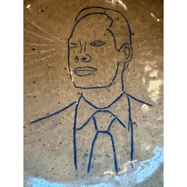 Fabulous Mid-Century studio pottery bowl featuring a man wearing a tie. Rays of light appear to be coming out of his eye...