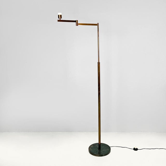 Italian Art Deco brass floor lamp with adjustable arm and dark marble base, 1940s. Floor lamp with a round base. The...