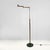 Italian Art Deco brass floor lamp with adjustable arm and dark marble base, 1940s. Floor lamp with a round base. The...