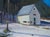 Within the Snow by Samantha Buller | Oil on panel depicting a snow-covered landscape with a house. For Sale