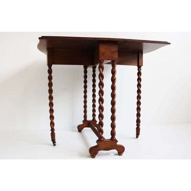 Gorgeous English 19th century barley twist gateleg / foldable table with inlaid top. Very nice walnut burl top with inlaid...
