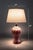 A sculptural vintage Hollywood Regency table lamp featuring a soft blush-pink glazed ceramic body with elegant spiral...