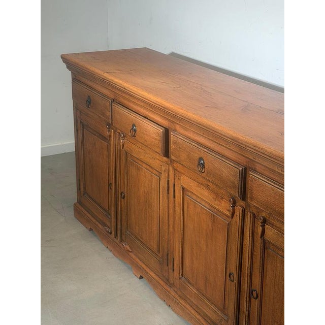 Beautiful vintage wooden sideboard originating from India, featuring a warm tone and timeless craftsmanship. This piece...