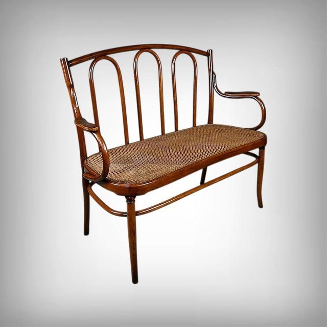 This bentwood bench, stamped J&J Kohn, is distinguished by the natural elegance of its lines and the exceptional mastery...