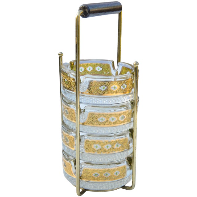 Beautiful and festive set of four midcentury 22-karat gold Culver glass ashtrays with an ornate hand-painted pattern in...