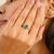 Crafted in luminous 14k white gold, this elegant ring features a vibrant 1.09 carat emerald-cut green emerald as its...