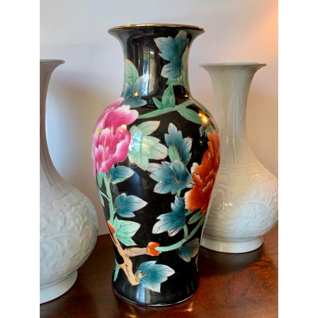 Chinese hand painted porcelain vase featuring colorful peonies in pink, rust orange, yellow, and light green against a...