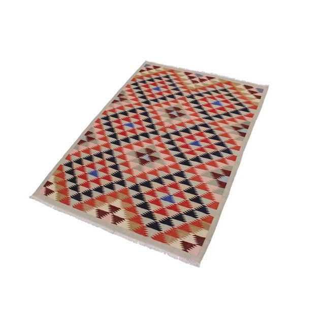 "Add a touch of elegance to your home with this casual chic hand woven Tribal Kilim wool rug. Constructed on a loom by...