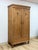 This antique European wardrobe showcases the warm, natural grain of solid pine, that highlights the wood's authentic...