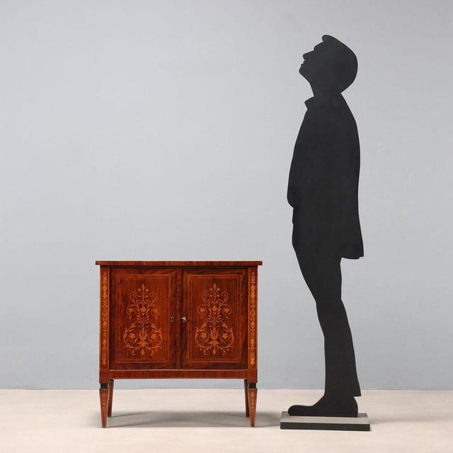 Neoclassical-style sideboard veneered in rosewood and mahogany, with full-surface maple floral and leaf scroll inlays and...