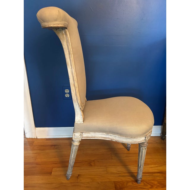 A Louis XVI Cockfighting Chair, circa 1780-1800, with a bulbous seat and typical back, made to straddle with an armrest at...