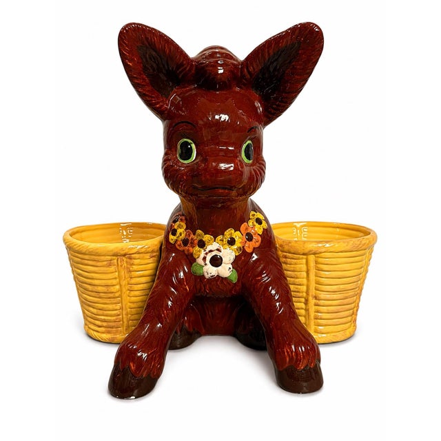 A wonderfully whimsical and highly sculptural vintage ceramic donkey planter featuring two large integrated basket-form...