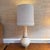 This sculptural mid-century modern table lamp features a striking cork body with an elongated neck rising from a rounded...