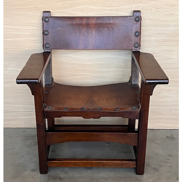 19th century walnut Spanish colonial altar armchairs with leather back and seat The unusual size of the arms complete this...