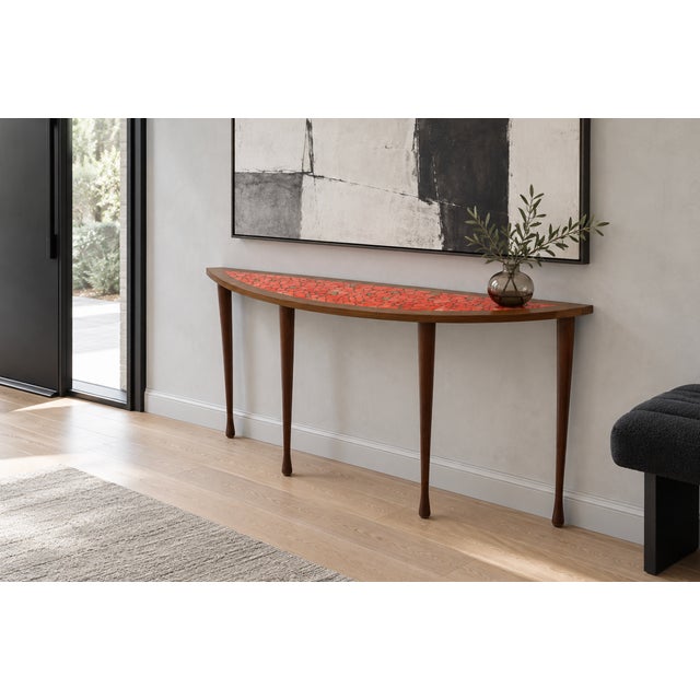 Mid Century Modern semi-round console table featuring a vibrant orange mosaic top framed in warm brown wood. Its shallow...
