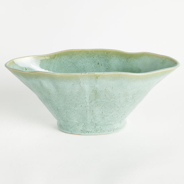 With a sculptural form and slim profile, this vase is made for narrow console or mantle. Drape a faux stem or two along...