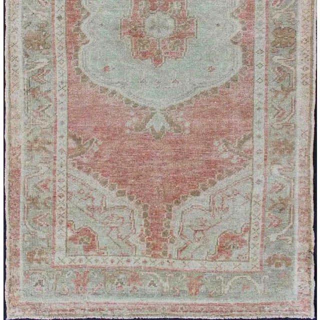 Measures: 2'11 x 5'8. Vintage Turkish Oushak Medallion Rug in Soft Coral, Mint Green, and Beige Tones. Keivan Woven Arts /...