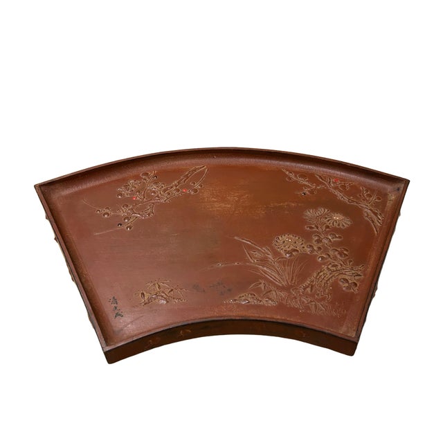 This Chinese fan-shaped tray, crafted from wood with a deep brownish cinnabar-toned lacquer finish, is a beautiful example...