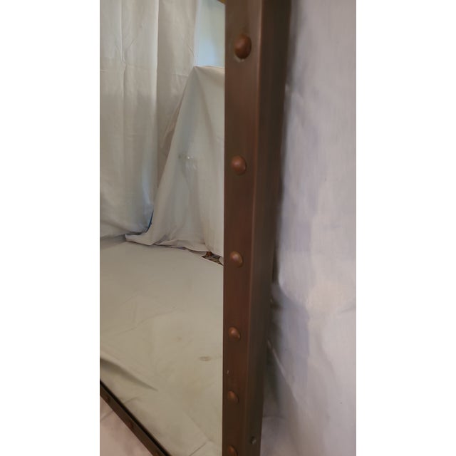 This is a great, industrial, steel framed mirror with an oxidized, riveted frame. Very sturdy.