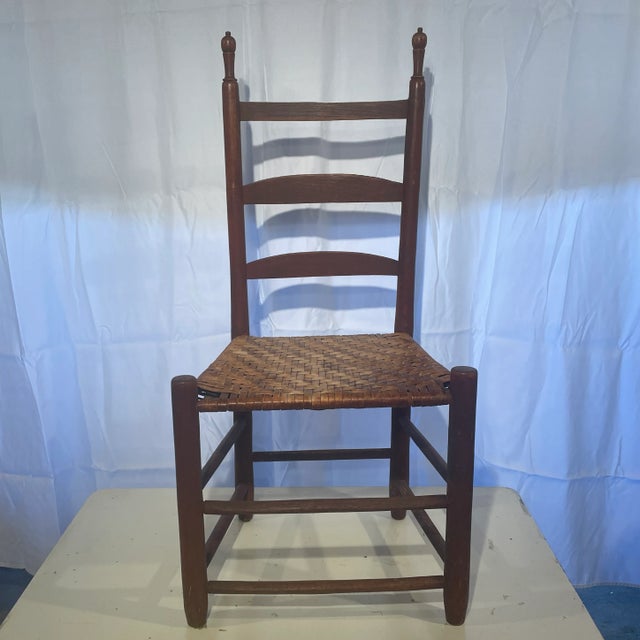 Beautiful antique ladder back chair with wooden seat.